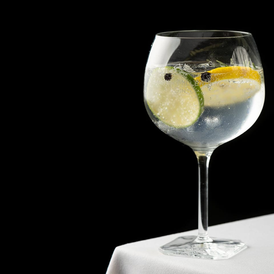 Gin cocktail with cucumber lemon and ice
