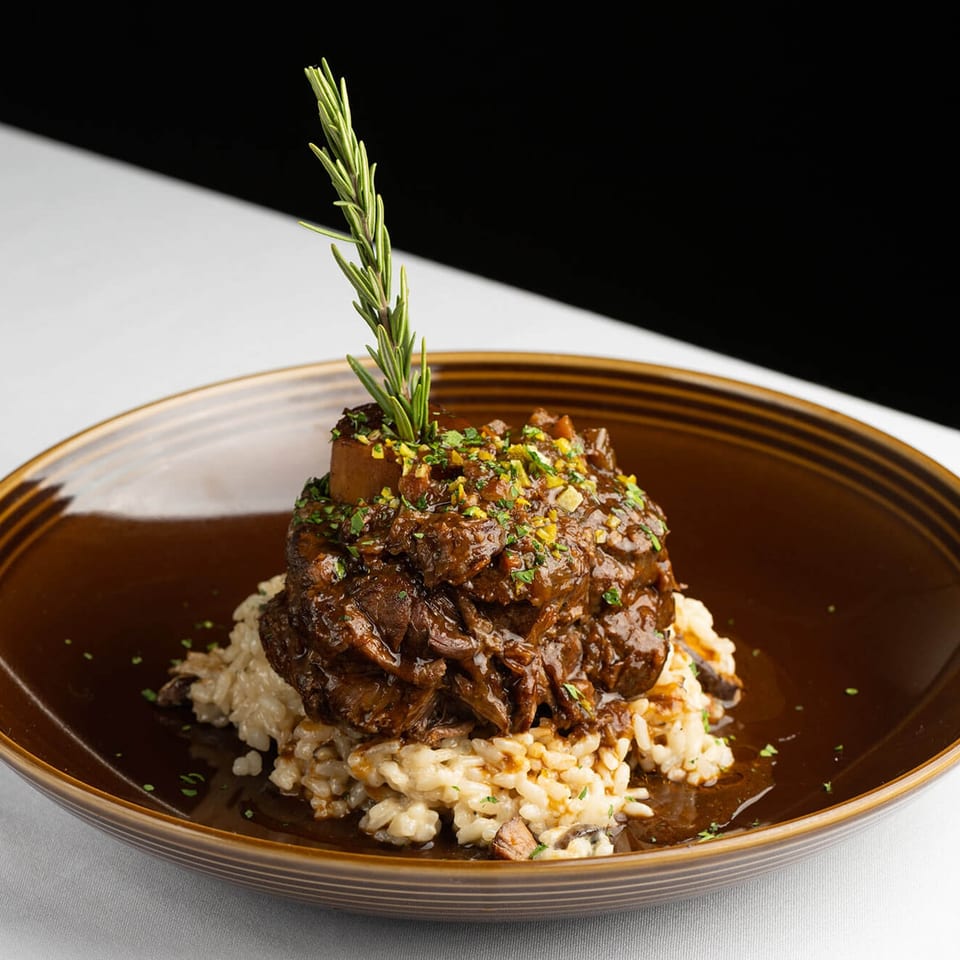 Braised meat served over risotto