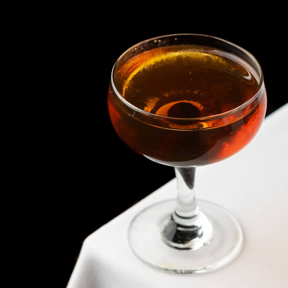 Amber cocktail in a coupe glass