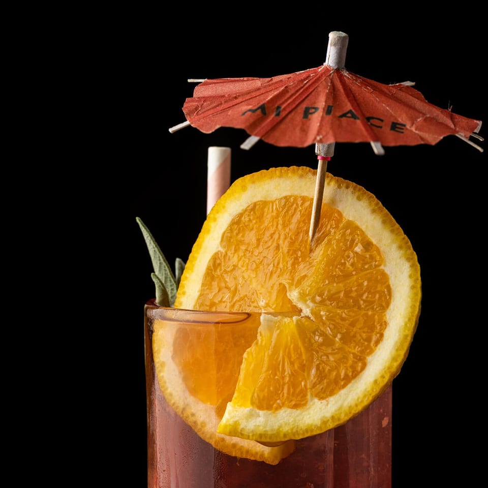 Cocktail with Mi Piace branded umbrella
